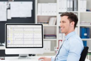 Smiling confident businessman at his desk